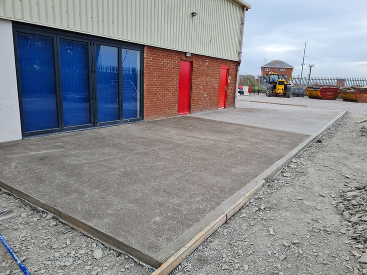 Concrete base beside structure