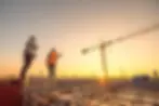 Engineers on site with crane in the background