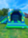 Green and blue bouncy castle with slide