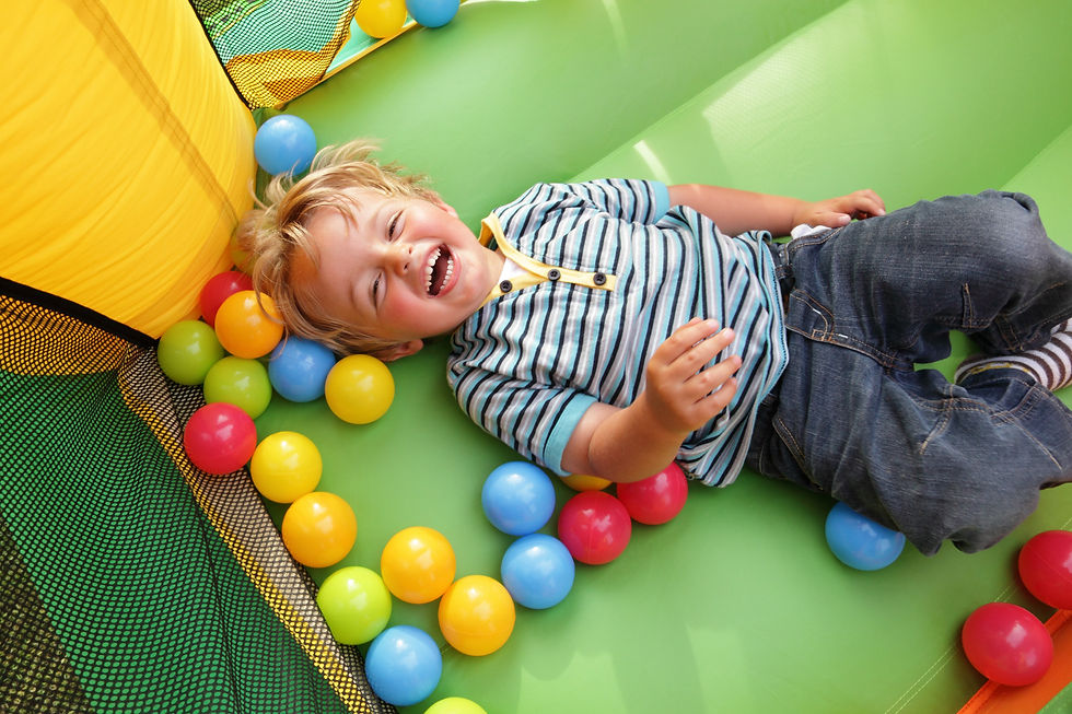 Lad lying on his back on bouncy castle