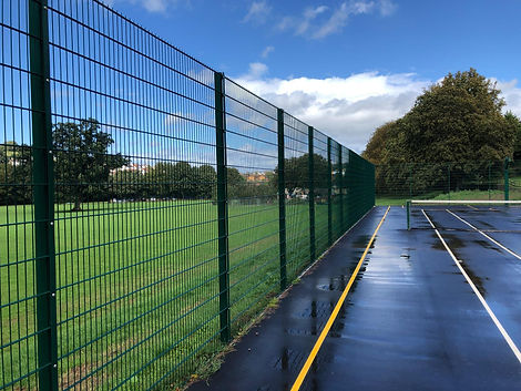 Tall meta fence around tennis court