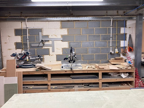 Joinery equipment on a workbench which has shelving underneath
