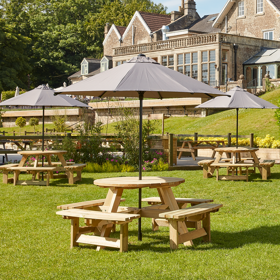 Thumbnail: Round 8 seater wooden picnic benches with grey parasols.