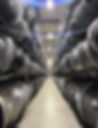 isle of stacked shiny wheels in our warehouse