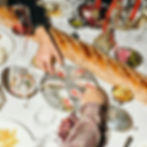 People at a shared dinner table in Melbourne laughing and eating together