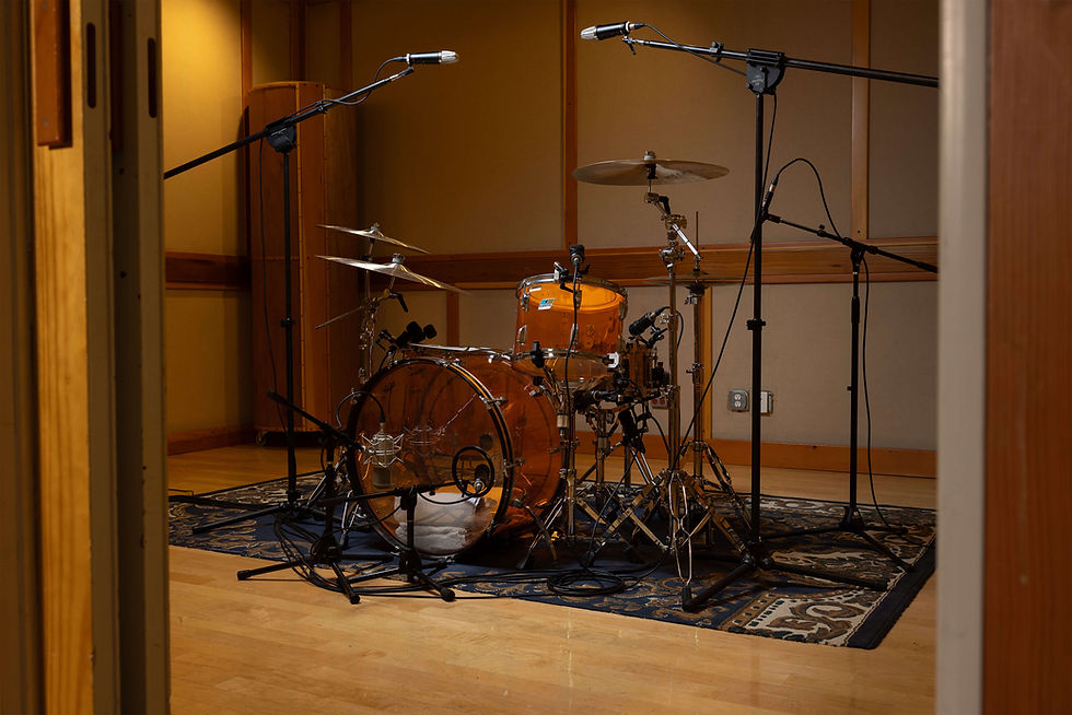An orange Ludwig drum set in a small isolation room with eight Rim Mounts attached.