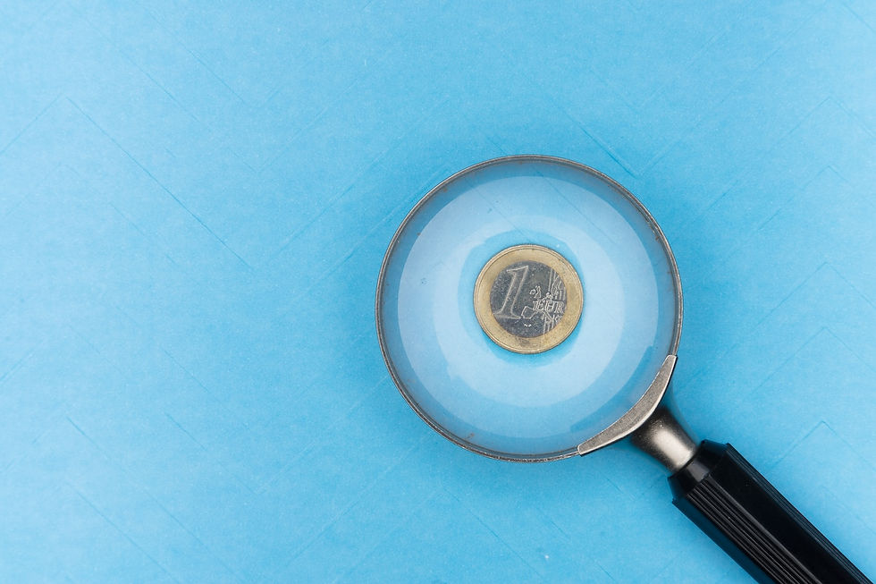 magnifying glass looking at coin