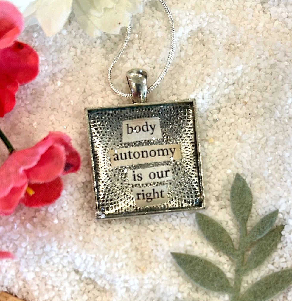 Close-up view of a silver bracelet with a raised fist symbol