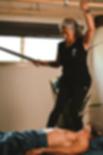 Massage therapist using Ashiatsu barefoot massage techniques