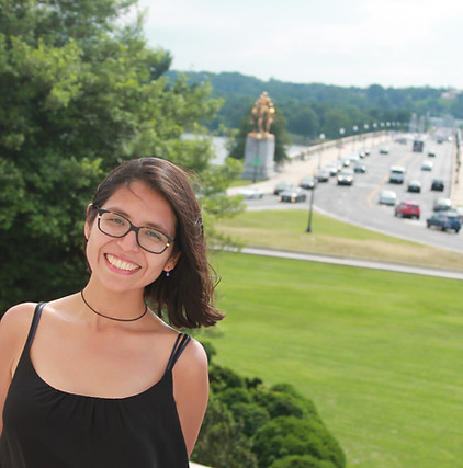 Susana Paola Navas standing in front of a nature-inspired backdrop, symbolizing climate policy advocacy, youth leadership, an