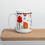 Thumbnail: Left view of a white an 15oz Christmas mug designed with trees and homes on a desk for sale