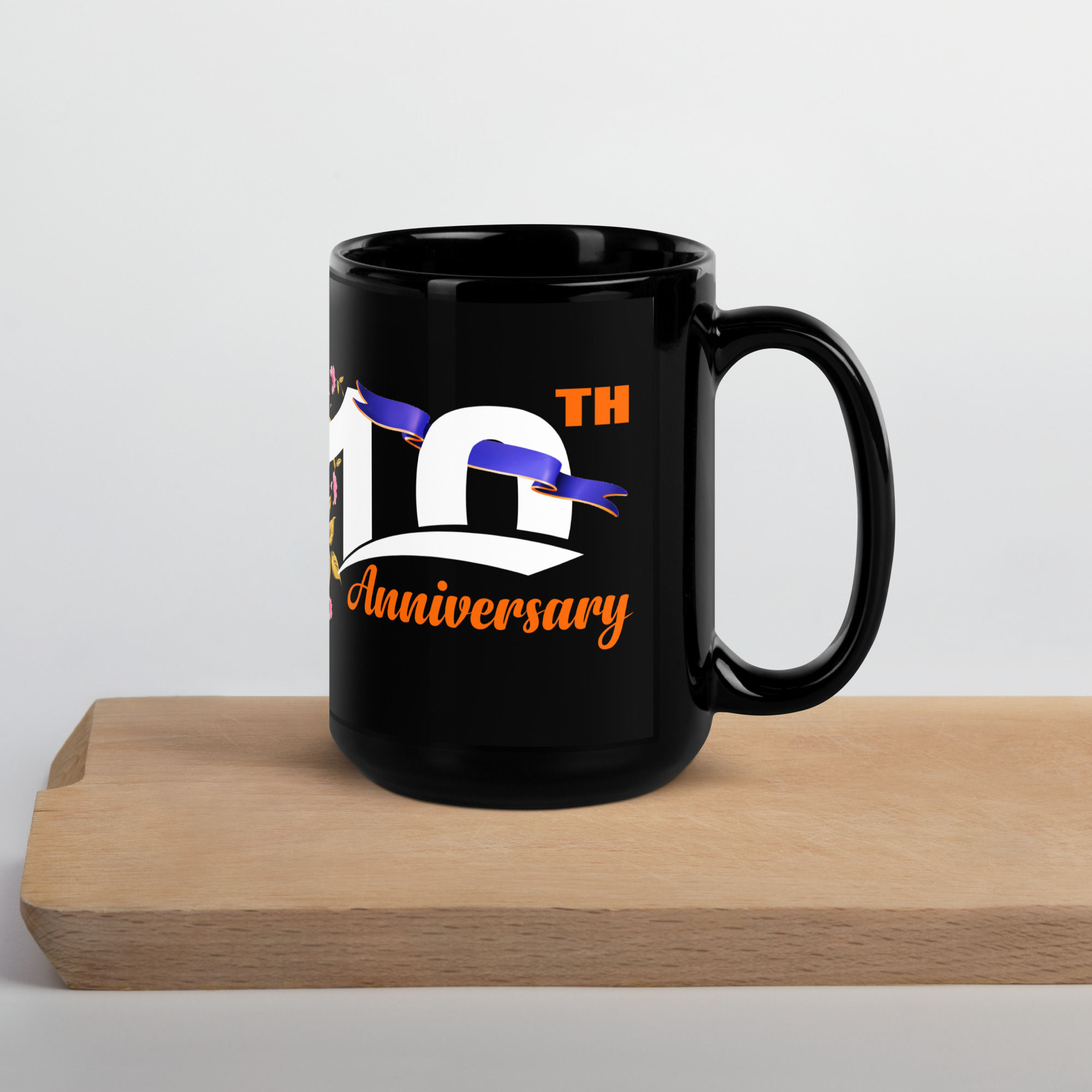 Right-side view of a 10th anniversary 11oz mug designed with a blue ribbon and orange color inscription of Anniversary