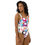 Thumbnail: Right-side view of a lady wearing a colorful one-piece swimsuit for women looking rightwards