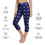Thumbnail: Front view of a lady wearing deep blue yoga capri leggings designed with stars  displaying apparel statistics