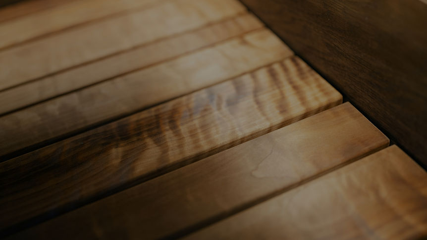 Close-up of wooden planks with a rich, textured grain pattern and warm, natural tones._edi
