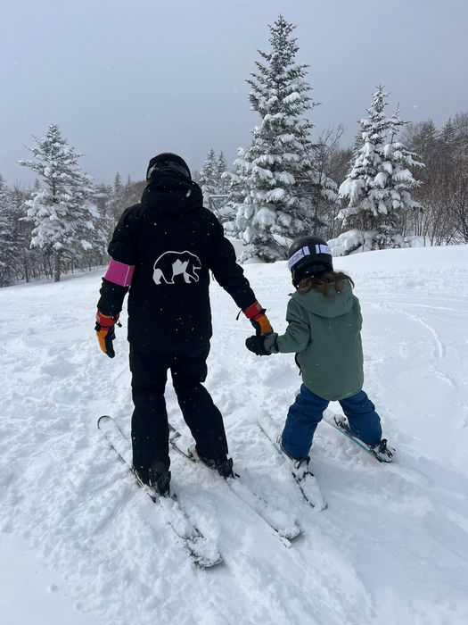 Otaru Adventure ski instructor holding a little kids hand while skiing in Japan.