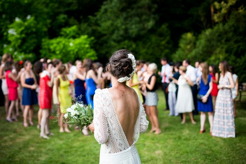 Bride getting ready to throw her wedding bouquet to her friends