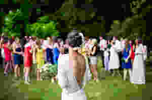 Bride getting ready to throw her wedding bouquet to her friends
