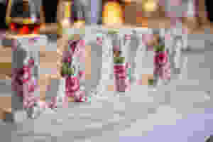 Floral letters spelling the word LOVE on a white tablecloth