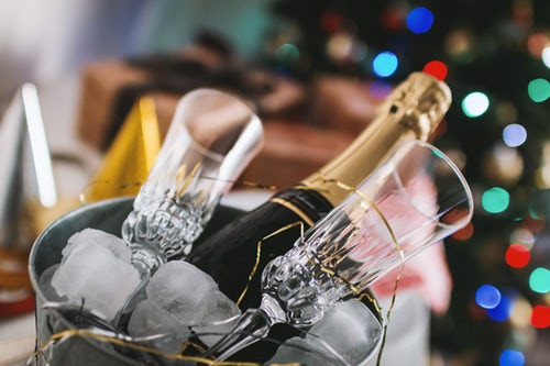 Bottle of champagne and two glasses in an ice bucket