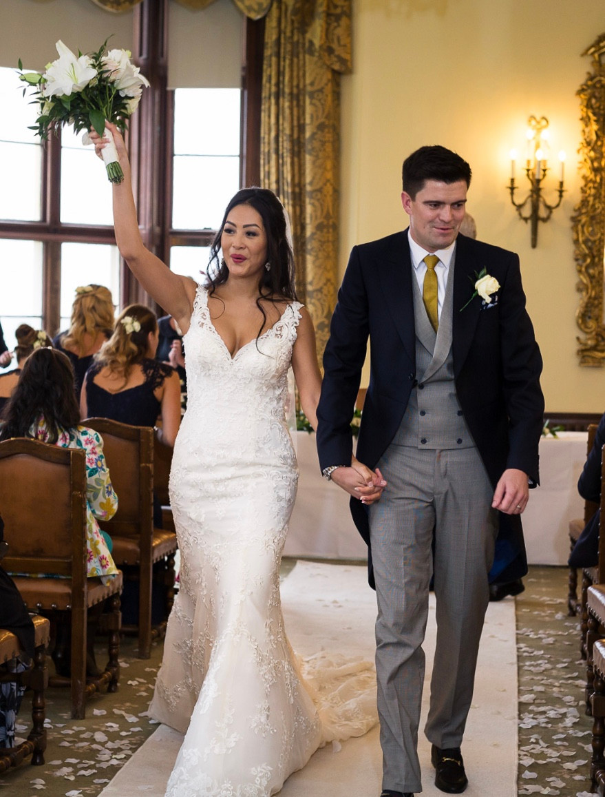 Happy bride and groom walking down the aisle after their celebrant wedding ceremony