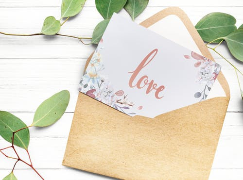 Open envelope with a card with the word Love