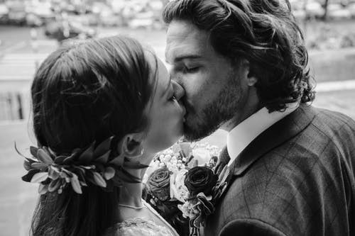 Bride and groom kissing after their wedding ceremony