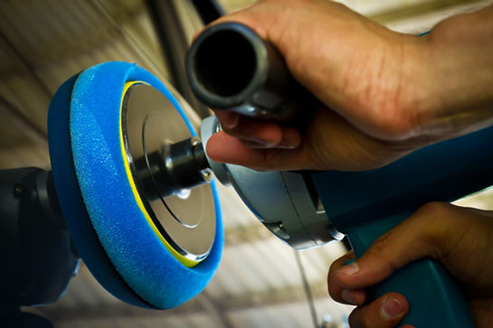 Man doing paint correction on a car