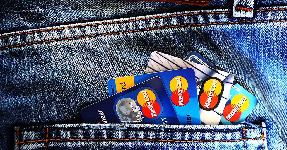 Close-up of a denim pocket with multiple credit cards, illustrating finance and fashion.