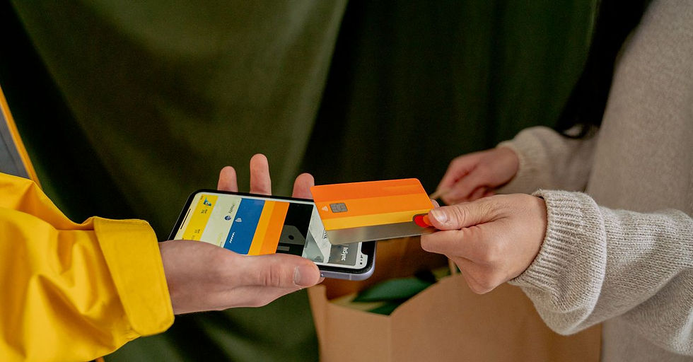 A close-up of a contactless payment using a credit card and smartphone, highlighting modern technology.