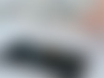 Calculator application on mobile phone screen on white surface near crop anonymous person holding pile of dollars