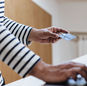 Person using a credit card for online shopping on a laptop indoors.