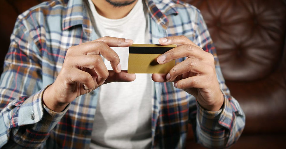 Person holding a credit card, focusing on hands and card for financial themes.
