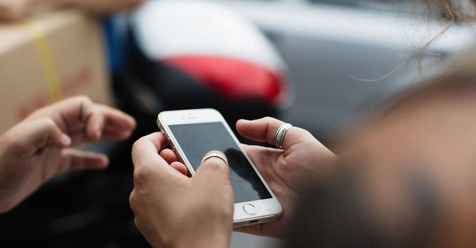 Person using a phone app to compare Kikoff vs Dovly for credit building and financial management