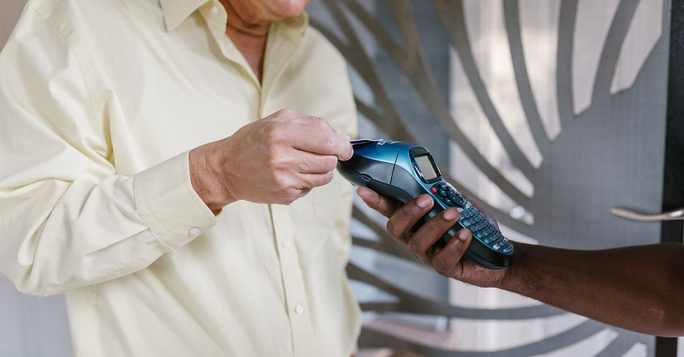 Man using credit card on a payment terminal for a cashless transaction indoors.