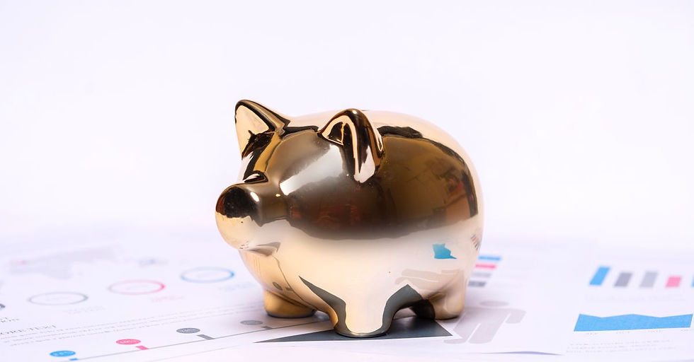 Close-up of a golden piggy bank on financial documents, symbolizing savings and investment.