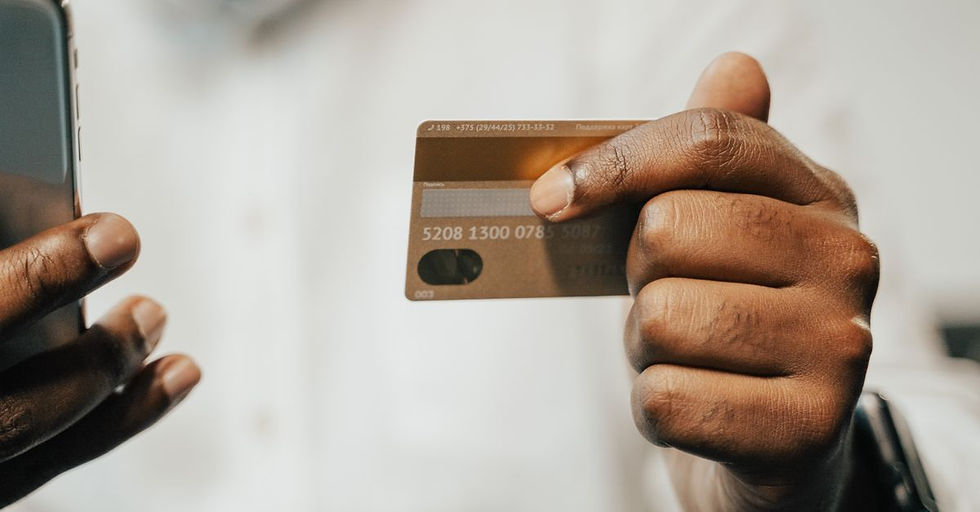 Person using a smartphone and credit card for online shopping or payment.