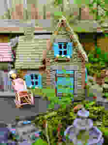 Fairy garden cottage with fairy fountain and miniature doll