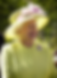 Queen Elizabeth wearing a hat and bright lemon yellow suit