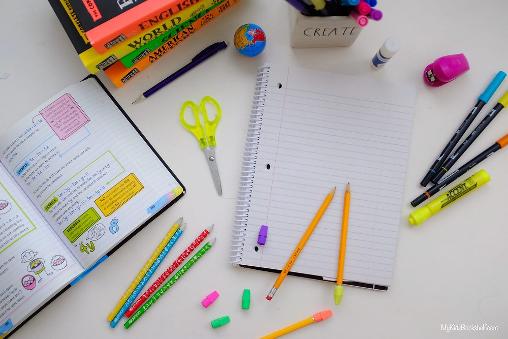 Brain quest books and notebook, pencils, scissors and stapler