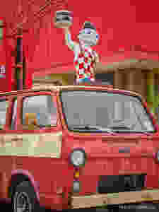 Currently Bookmarked old red van with vintage statue of boy in checked overalls holding a double burger