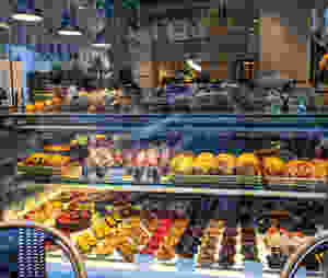 a-window-outside-a-bakery-with-rows-and-rows-of-pastries-and-breads