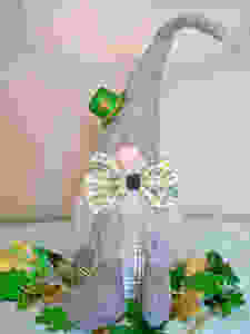 gnome with bowtie and green mini sparkly Irish hat surrounded by green clovers