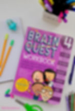 Brain Quest workbook for grade 4 with pencils, sharpener and paper