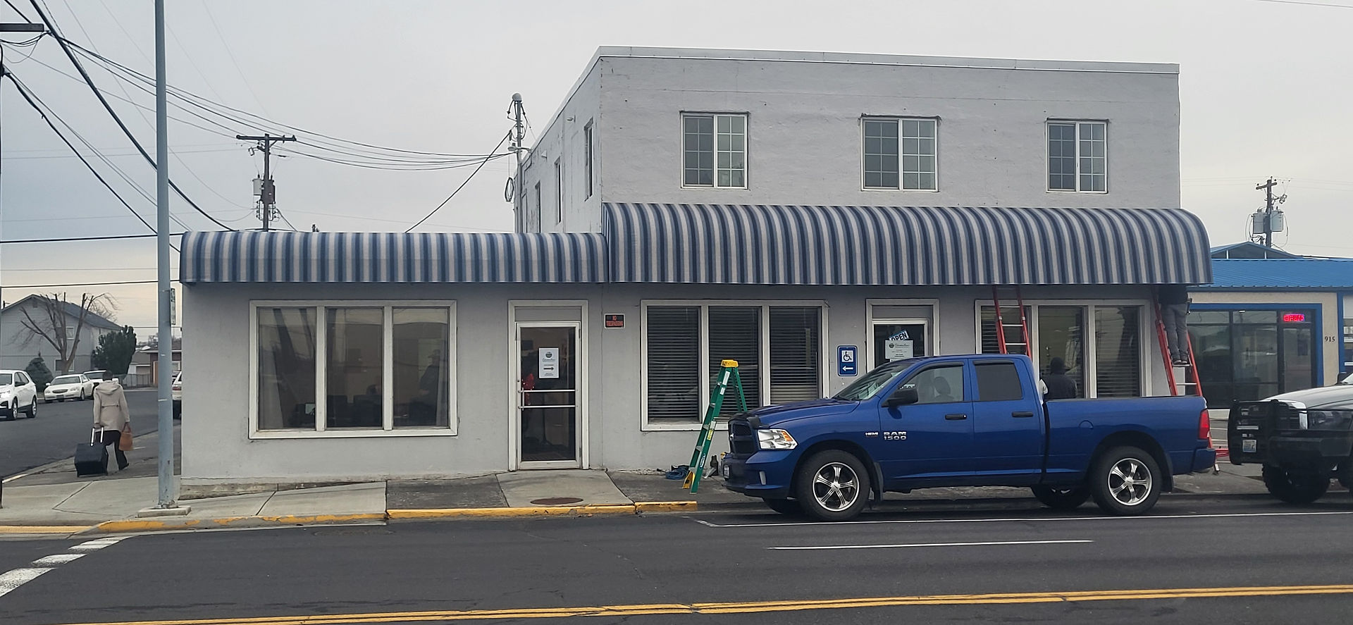 large building with a blue and white stripe awning
