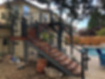 Newly installed stairs and railing coming from an upper deck.
