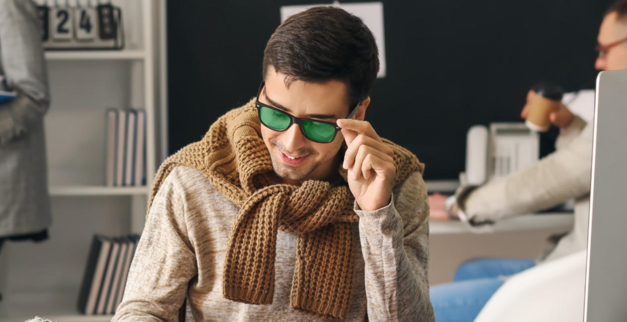 male accountant working in office with green