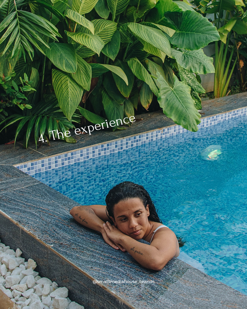 Woman relaxes in a blue pool by lush tropical plants; text reads 4. The experience and @smallmediahouse_brands at the Bali Resort, Zanzibar