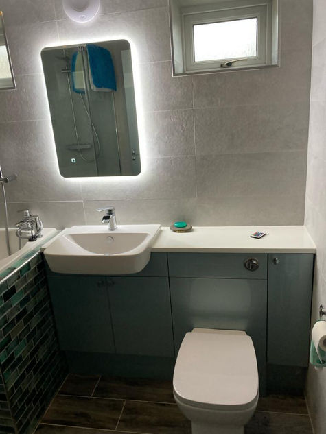 modern bathroom design with lighted mirror and white sink
