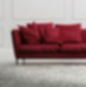 Vibrant interior scene featuring a bold red sofa, a plush fur-style rug, and a white decorative wall as the backdrop.